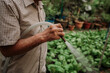 © Marija Savic/Stocksy - Old Chinese Man Working in Community Garden