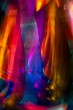 © Catherine MacBride/Stocksy - Stock photo of a very bright colourful abstract of light shot through cut glass crystal