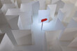 © Catherine MacBride/Stocksy - How do we get out of this? a red paper arrow points the way out of a white paper maze.