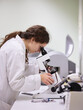 © MIQUEL LLONCH/Stocksy - Young woman working with microscope