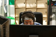© Danil Nevsky/Stocksy - Pensive trendy man using computer with interest in modern office