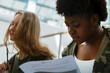 © Danil Nevsky/Stocksy - Pensive diverse students at lecture in light modern auditorium of college