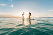 © Alison Winterroth Photography/Stocksy - Two Girls Jumping In Water
