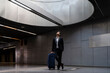 © VITTA GALLERY/Westend61 - Thoughtful businessman with suitcase looking through skylight while standing at station