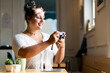 © Giorgio Fochesato/Westend61 - Close-up of smiling woman looking photograph over camera while sitting in coffee shop