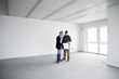 © MiJo/Westend61 - Architect and construction worker discussing blueprint while standing in empty house