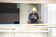 © MiJo/Westend61 - Construction worker using digital tablet while sitting on steps at construction site