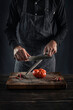 © Manuel Sulzer/Westend61 - Man sharping knife while standing at table