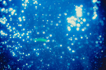 Wall Mural - Abstract blue defocused bokeh of lights in dark