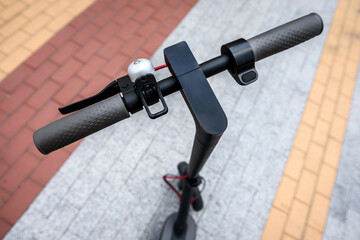 Close up of the steering wheel of an electric scooter