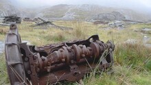 A Rusted Piece Of Recked Machinery Lying On A Welsh Mountainside Above A Quarry Near Teh Abandoned Miner’s Village Of The Cwmorthin Slate Quarry In The Moelwyn Mountains Near Tanygrisiau, North Wales.