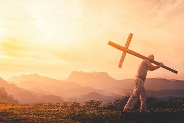 Wall Mural - Silhouette of human carry cross on mountain sunset
