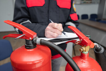 Wall Mural - engineer professional are checking a fire extinguisher and writes data to the check log. fire alarm 