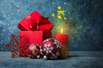 Wall Mural - Red gift box with shiny satin bow for surprise, candle and christmas balls