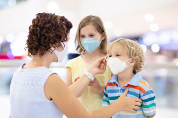 Wall Mural - Mother and child with face mask and hand sanitizer