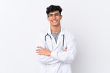 Fototapeta Na drzwi - Young Argentinian man over isolated white background wearing a doctor gown and with arms crossed