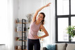 © Syda Productions - sport, fitness and healthy lifestyle concept - smiling young woman exercising at home