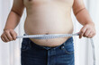 © Charlie's - Man with fat belly in dieting concept. Overweight man touching his fat belly and want to lose weight.