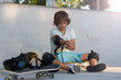 © Jose Prieto - Procedure to protect from falls Preparing to skate. Teenagers spending free time practicing Skateboard