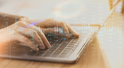 Poster - Stock market trading graph chart layered over female hands working on laptop
