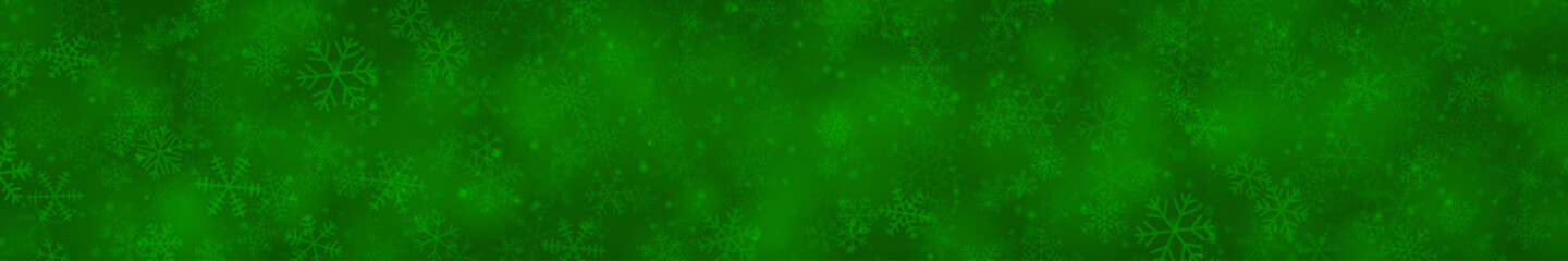 Christmas banner of snowflakes of different shapes, sizes and transparency on green background