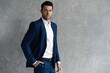 © opolja - Handsome man wear blue suit isolated on grey background