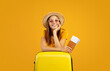 Happy young woman in sunglasses holding passport and tickets