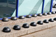 hostile design steel half ball mounted on the edge of the curb prevents the homeless sitting