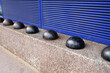 hostile design steel half ball mounted front of building on the edge of the curb street