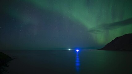 Wall Mural - aurora borealis reflecting in ocean water over ships iceland