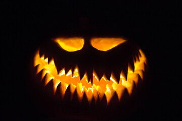 Halloween pumpkin glowing face in the dark