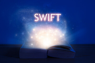 Wall Mural - open book with swift inscription. light coming from open book with words swift. learn swift programm