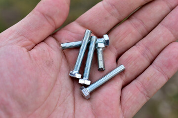 Wall Mural - Shiny iron bolts in the worker's hand