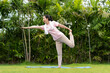 © NVB Stocker - Young woman doing yoga in morning backyard at home. Outdoor workout healthy lifestyle concept.
