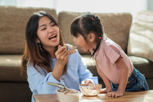 Happy Asian Child Enjoy Eating Ice Cream With Her Older Sister