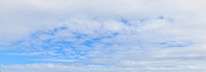 Wall Mural - Image of a partly cloudy and partly clear sky during the day