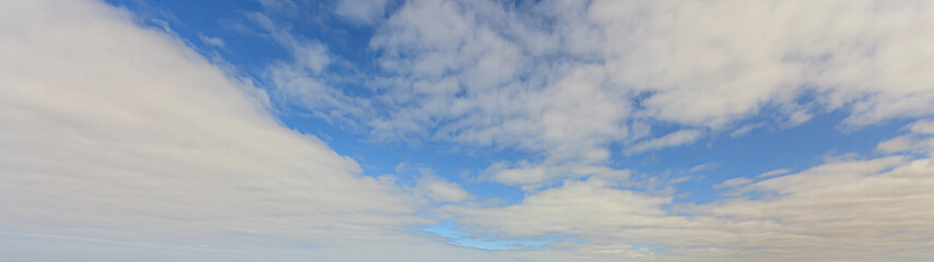 Wall Mural - Image of a partly cloudy and partly clear sky during the day