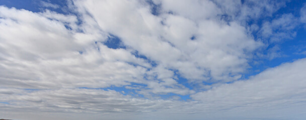 Wall Mural - Image of a partly cloudy and partly clear sky during the day