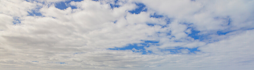 Wall Mural - Image of a partly cloudy and partly clear sky during the day