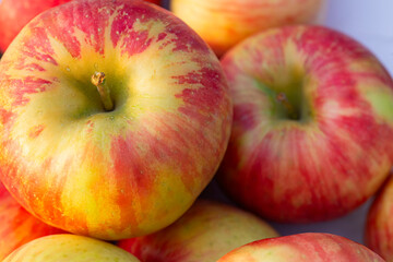 Wall Mural - stack of apples on a white table with shallow focus