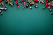 Christmas Border With Classic Decorations. Fir Branches, Red Balls, Jingle Bells On Green Background.