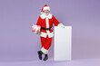 © ViDi Studio - Full length portrait Santa Claus man in Christmas hat suit hold big white empty blank billboard present box with gift ribbon isolated on violet background. Happy New Year celebration holiday concept.