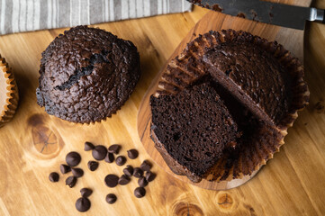 Wall Mural - jumbo chocolate muffin on wooden background