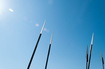 Details of the architecture - stylized spearheads that rest against the sky. Memorial sign at the site of an ancient battle. Historical places - tourism, Hiking.