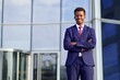 © Евгений Шемякин - Portrait of serious confident successful black African man, Afro American young businessman in formal suit with tie standing outdoors business office with his hands crossed, looking at camera