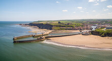 Aerial View Of East And West Piers Each With A Lighthouse And Beacon, Whitby, UK.