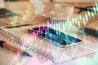 © peshkova - Double exposure of forex chart drawing and cell phone background. Concept of financial data analysis