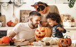 © JenkoAtaman - Happy multi ethnic family preparing for Halloween celebration.