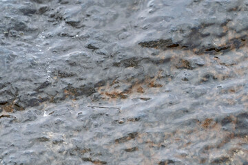 Top view of a coastal rock washed by river water