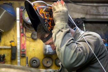 Wall Mural - Close-up portrait of a welder in the workplace